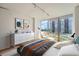 Modern main bedroom with furniture, neutral decor, and large windows providing natural light and community views at 3100 E Cherry Creek South Dr # 404, Denver, CO 80209