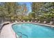 Inviting outdoor pool with surrounding lounge chairs and mature trees at 3100 E Cherry Creek South Dr # 404, Denver, CO 80209