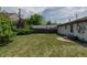 A well kept backyard with a grass lawn, patio and privacy fence at 1540 S Knox Ct, Denver, CO 80219