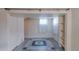 Basement space featuring tiled floor, closet, and window at 1540 S Knox Ct, Denver, CO 80219