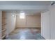 Unfinished basement space with tiled floors and potential for customization at 1540 S Knox Ct, Denver, CO 80219