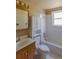 Bright bathroom with vanity, toilet, cabinet, and tiled shower/tub combination at 1540 S Knox Ct, Denver, CO 80219