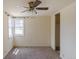 Bedroom with carpet, bay window, fan, and closet at 1540 S Knox Ct, Denver, CO 80219