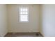 Small carpeted bedroom featuring a window and neutral-colored walls at 1540 S Knox Ct, Denver, CO 80219