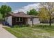 Charming single-story home with a well-maintained lawn and colorful landscaping at 1540 S Knox Ct, Denver, CO 80219