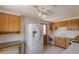 Functional kitchen with wooden cabinets and modern white refrigerator at 1540 S Knox Ct, Denver, CO 80219