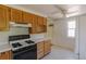 Efficient kitchen layout with white countertops and updated appliances at 1540 S Knox Ct, Denver, CO 80219