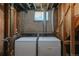 Unfinished laundry area featuring side by side washer and dryer hookups in the basement at 1540 S Knox Ct, Denver, CO 80219