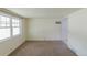 Spacious living room with ample natural light and neutral carpeting at 1540 S Knox Ct, Denver, CO 80219