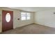 Inviting living room featuring a large window and neutral carpeting at 1540 S Knox Ct, Denver, CO 80219