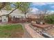 Spacious backyard featuring a deck, fire pit area, and stone pathway, offering a serene outdoor experience at 10475 E Abilene St, Commerce City, CO 80022