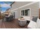 The beautiful backyard deck features a dining area, fire pit, and comfortable lounge seating for outdoor enjoyment at 10475 E Abilene St, Commerce City, CO 80022