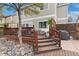 Multi-level deck with stairs, grill, and landscaped surroundings, designed for outdoor entertaining and relaxation at 10475 E Abilene St, Commerce City, CO 80022