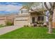 Charming two-story home with a well-manicured front yard and inviting porch at 10475 E Abilene St, Commerce City, CO 80022