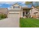 Charming two-story home with a well-manicured front yard and inviting porch at 10475 E Abilene St, Commerce City, CO 80022