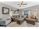 Bright living room with a large sectional sofa, floating shelves, and stylish decor for a cozy atmosphere at 10475 E Abilene St, Commerce City, CO 80022