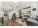Bright living room featuring a vaulted ceiling, large windows, and hardwood floors at 10475 E Abilene St, Commerce City, CO 80022