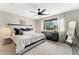 Relaxing main bedroom featuring a large bed, stylish decor, and an abundance of natural light at 10475 E Abilene St, Commerce City, CO 80022