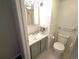 Bright and clean bathroom with white tile, shower and olive green cabinets with modern fixtures at 1020 15Th St # 21M, Denver, CO 80202