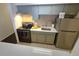 Stylish kitchen includes stainless steel refrigerator, range, and updated countertops and olive green cabinets at 1020 15Th St # 21M, Denver, CO 80202