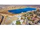 Stunning aerial view of a home near a picturesque lake, offering serene waterfront living with beautiful landscape at 14955 W 58Th Pl, Golden, CO 80403