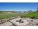 Backyard with a fire pit area overlooking a lake and green space at 14955 W 58Th Pl, Golden, CO 80403