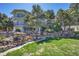 Multi-story home with balconies, rock gardens, mature trees, and well-maintained lawn at 14955 W 58Th Pl, Golden, CO 80403