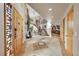 Bright foyer with tile flooring, staircase, arched doorways, and light wood accents at 14955 W 58Th Pl, Golden, CO 80403