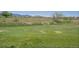 Expansive grassy land with distant houses and mountain views in the background at 14955 W 58Th Pl, Golden, CO 80403