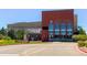 Community aquatic center featuring a modern brick building with large windows, a green lawn, and street access at 14275 Grape St, Thornton, CO 80602