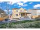 The backyard has a covered deck, a patio with a fire pit, and low-maintenance landscaping at 14275 Grape St, Thornton, CO 80602