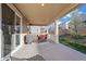 Relaxing covered deck with outdoor dining, grill, and views of the well-maintained lawn and neighborhood at 14275 Grape St, Thornton, CO 80602