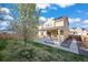 Beautiful home showcasing the backyard, covered deck, and solar panels for energy efficiency at 14275 Grape St, Thornton, CO 80602