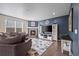 Cozy living room with fireplace, modern decor, plush seating, and hardwood flooring at 14275 Grape St, Thornton, CO 80602