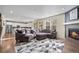 Spacious living area featuring an oversized sectional, fireplace, and seamless flow to the kitchen at 14275 Grape St, Thornton, CO 80602