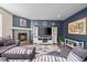 Cozy living room with fireplace, modern decor, plush seating, and hardwood flooring at 14275 Grape St, Thornton, CO 80602