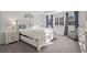 Bright main bedroom with carpet floors, large windows, and a king bed at 14275 Grape St, Thornton, CO 80602