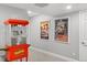 Finished basement features fun movie theater themed decorations and popcorn machine at 6591 N Ceylon St, Denver, CO 80249