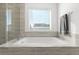 Inviting soaking tub with tile surround, a perfect spot to unwind at 6591 N Ceylon St, Denver, CO 80249