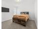 Cozy bedroom featuring carpeted floors, a bed, and a wall-mounted television at 6591 N Ceylon St, Denver, CO 80249