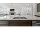 Kitchen island with seating and stainless steel appliances, showcasing a spacious layout at 6591 N Ceylon St, Denver, CO 80249