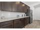 Kitchen with wood cabinets, granite countertop, stainless steel appliances, and modern lighting at 6591 N Ceylon St, Denver, CO 80249