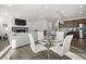 Open concept area including a living room fireplace plus a view of kitchen and dining area at 6591 N Ceylon St, Denver, CO 80249