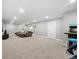 Open recreation room with a media area and arcade games, offering versatile spaces for relaxation and play at 6591 N Ceylon St, Denver, CO 80249