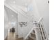 Bright and airy staircase with white railing and walls, leading to the upper levels at 6591 N Ceylon St, Denver, CO 80249