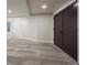 The basement is bright and spacious, featuring a double door entrance and cozy neutral carpeting at 5302 Pinehurst Dr, Boulder, CO 80301