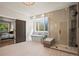 Bright bathroom featuring a freestanding tub, glass shower, and access to the main bedroom at 5302 Pinehurst Dr, Boulder, CO 80301
