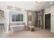 Bright bathroom with a freestanding tub, glass shower, and a window providing natural light at 5302 Pinehurst Dr, Boulder, CO 80301