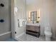 Modern bathroom featuring a sleek shower, vanity with stylish mirror, and hexagon tile flooring at 5302 Pinehurst Dr, Boulder, CO 80301