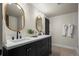 Bathroom boasts double vanity with quartz countertops, sleek black hardware, and modern lighting at 5302 Pinehurst Dr, Boulder, CO 80301
